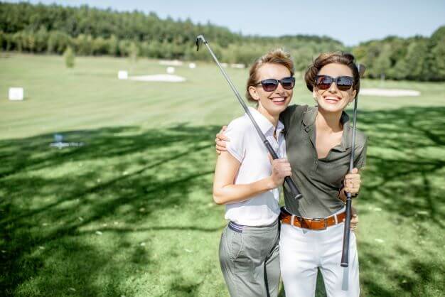 Two lady golfers wearing sunglasses